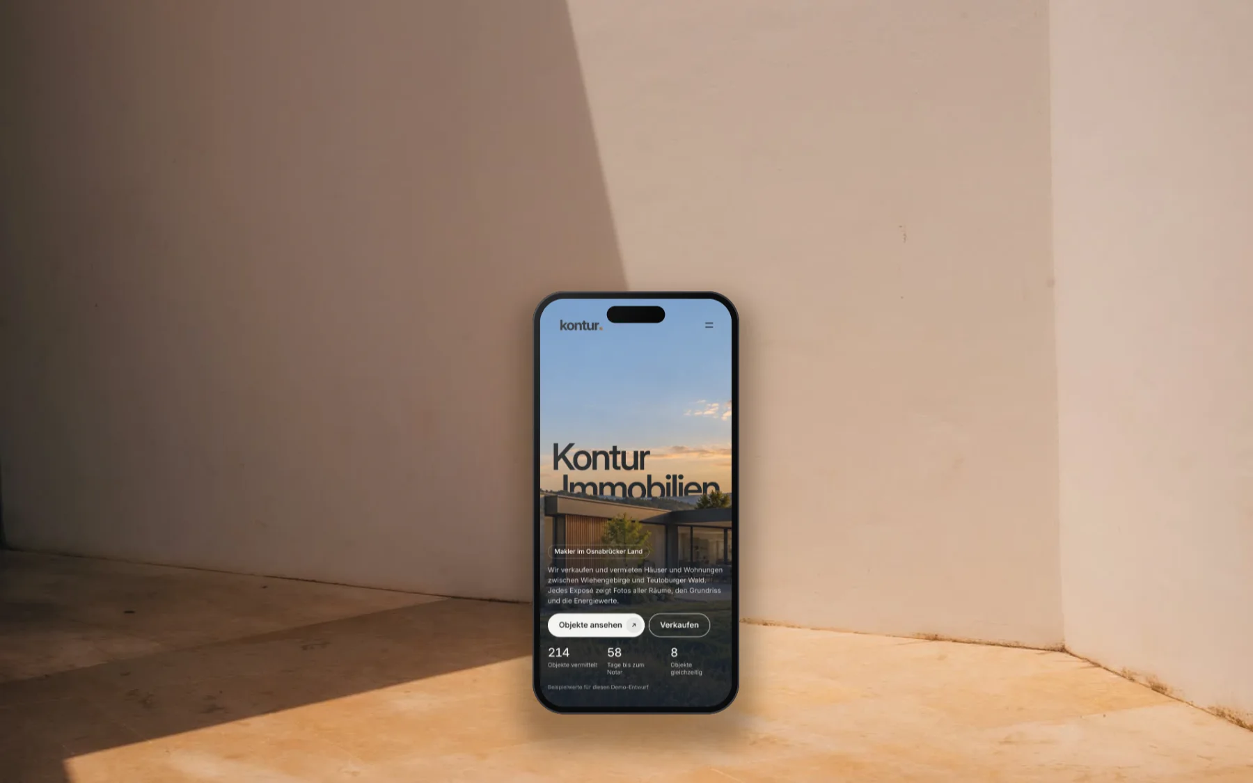 Hand hält ein Smartphone mit der Startseite der Demo Kontur Immobilien